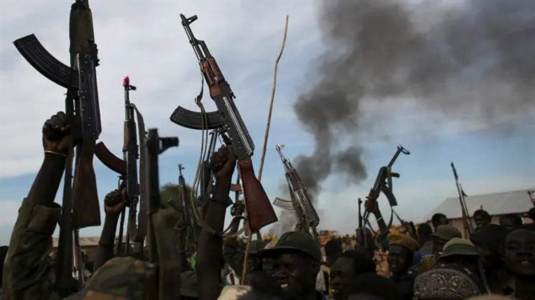 Rebel fighters in Sudan holding up rifles
