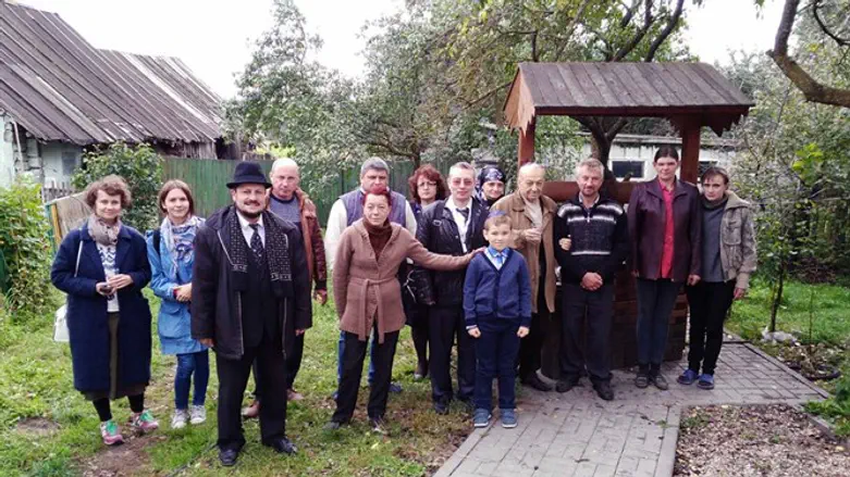 Residents of Vishnyeva gather outside Peres’ childhood home