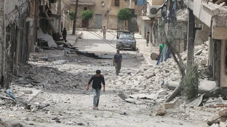 Residents walk through rubble in worn-torn Aleppo