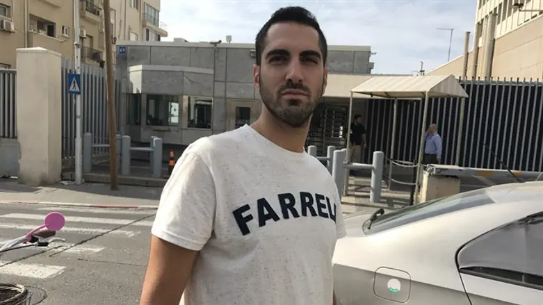Haim Levy standing across the street from the U.S. Embassy in Tel Aviv