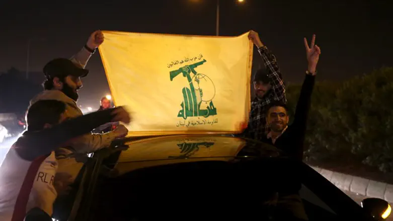 Hezbollah supporters hold a Hezbollah flag