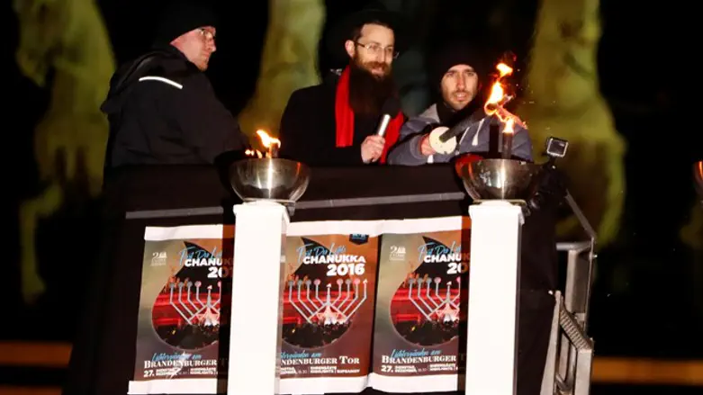 Or Elyakim (R) lights Hanukkah candles in Berlin