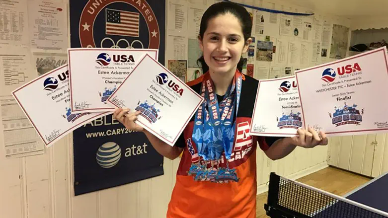 Estee Ackerman holding certificates representing the five medals she won