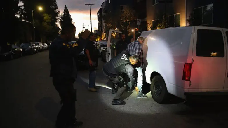 A man is detained by Immigration and Customs Enforcement agents in Los Angeles