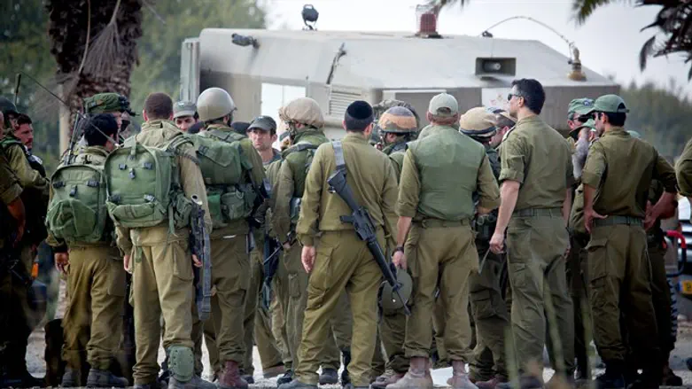 IDF reserve soldiers seen gathering in a staging area near the border with Gaza in Souther