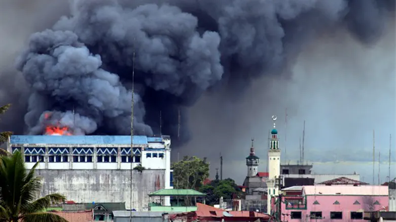 Black smoke comes from burning building in commercial area of Osmena street in Marawi