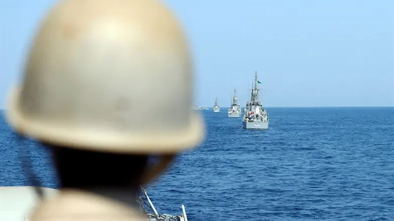 Member of Royal Saudi Navy looks at warship