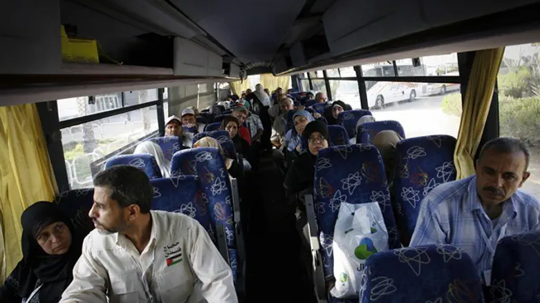 Gaza residents in bus leaving crossing