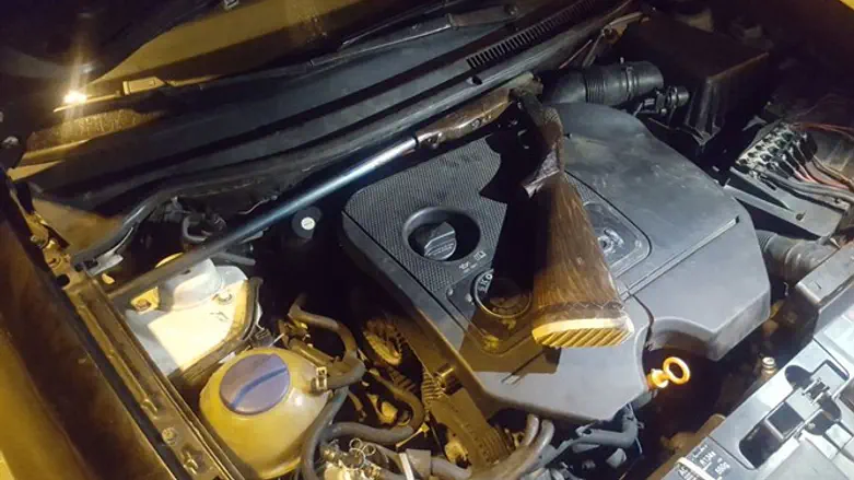 Gun found under car hood