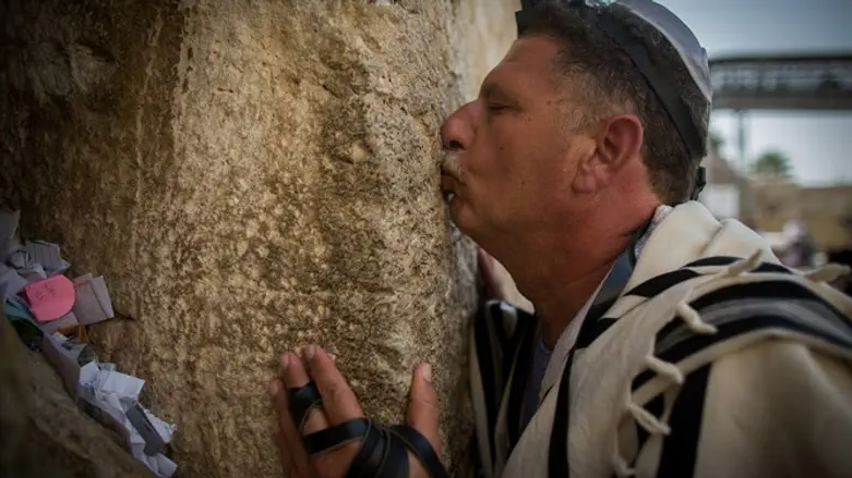 Worshipper kisses the Kotel