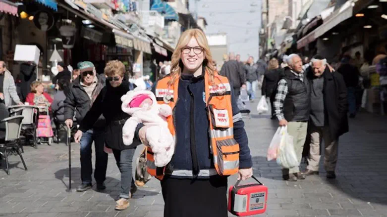 Miriam Ballin, holding her baby daughter, at the Mahane Yehuda market in Jerusalem.
