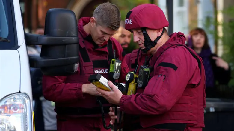 Bomb disposal squad stand in the street near Parsons Green tube station in London
