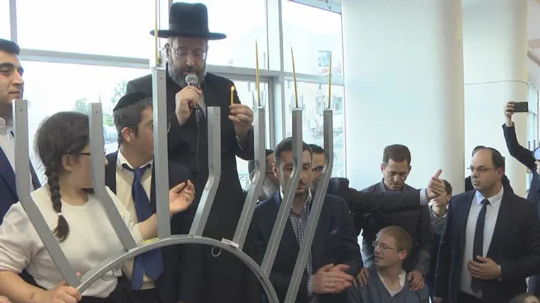 Chief Rabbi Lau lights Hanukkah candles with disabled children at Shalva