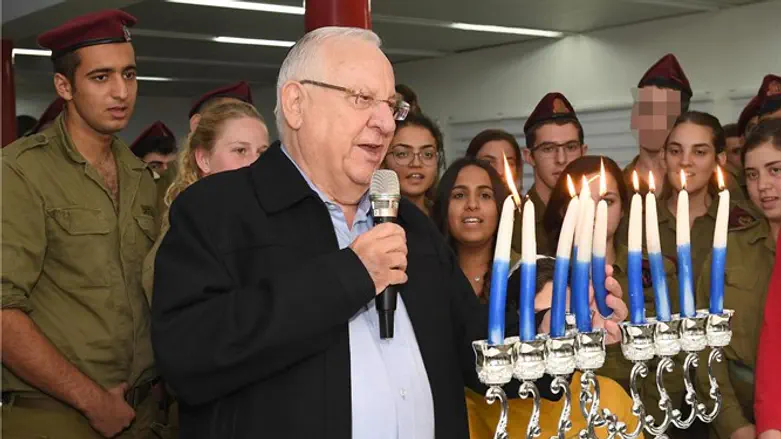 Rivlin lighting Hanukkah candles with soldiers