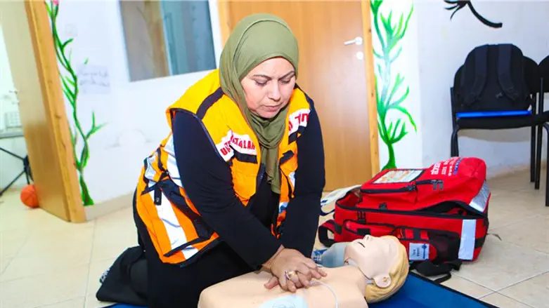 One of the newly trained Bedouin women performs CPR on a mannequin