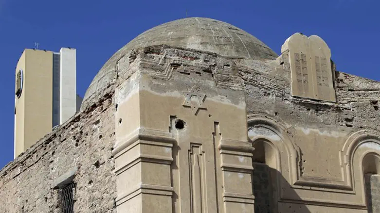 A hotel can be seen behind the abandoned Dar Bishi synagogue in Tripoli, Libya, Sept. 28,