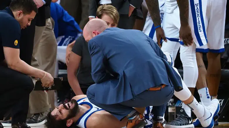Medical staff tend to Golden State Warriors forward Omri Casspi