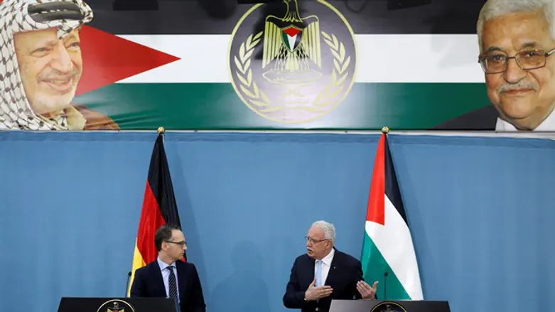 German FM Heiko Maas listens during news conference with PA FM