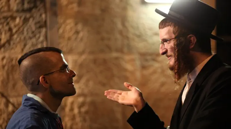 Haredi man speaks with secular man (illustrative)