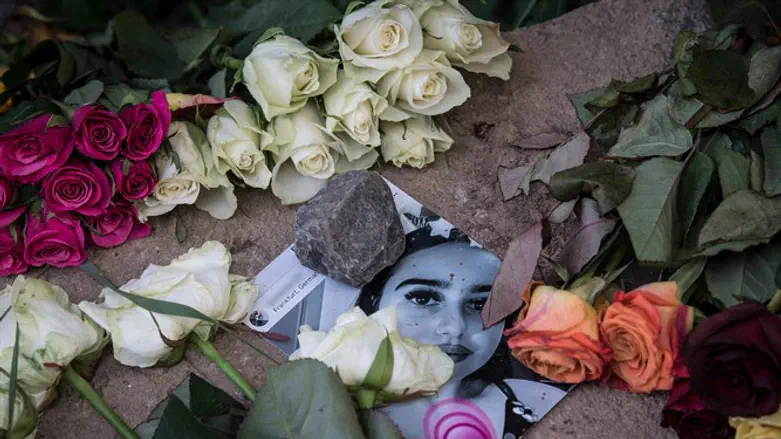 A picture of Susanna Maria Feldman is placed among flowers at a makeshift memori