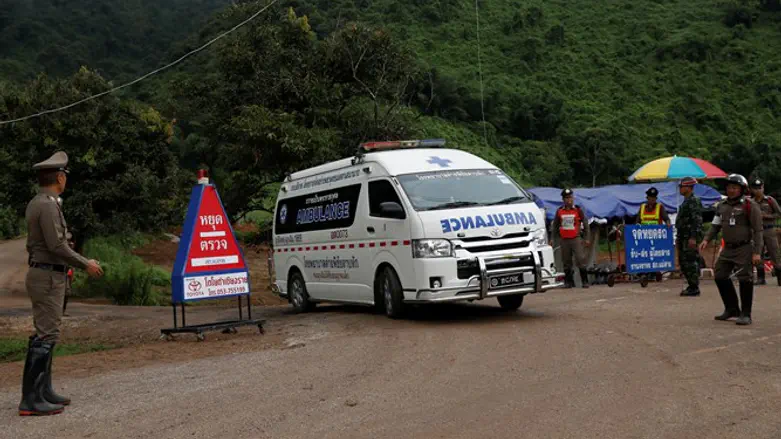 Rescue teams near entrance to flooded cave