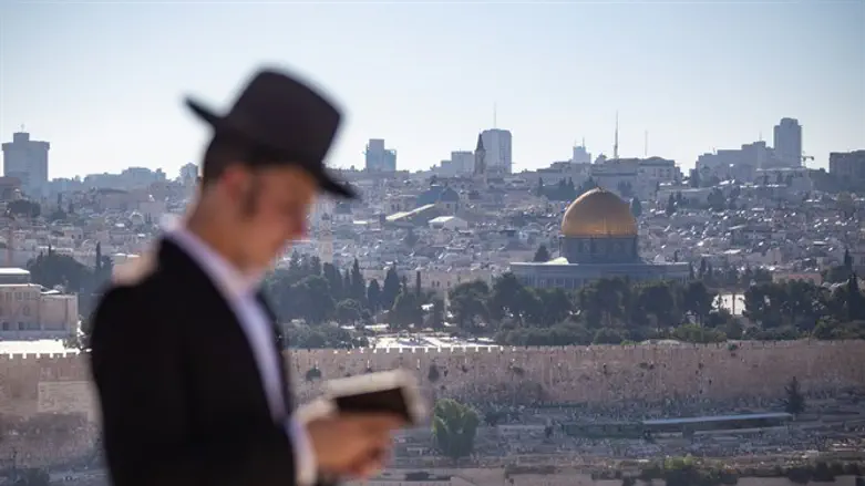 Jew prays on Mount of Olives facing Temple Mount