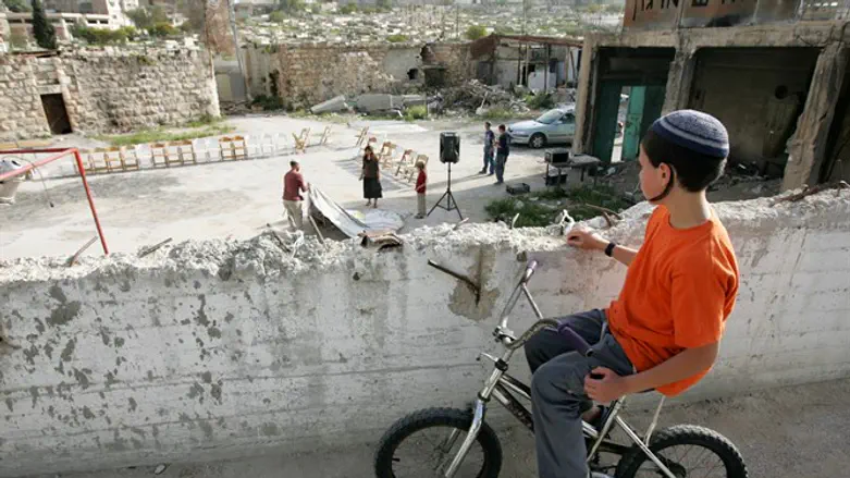 Jewish child rides bicycle in Hevron