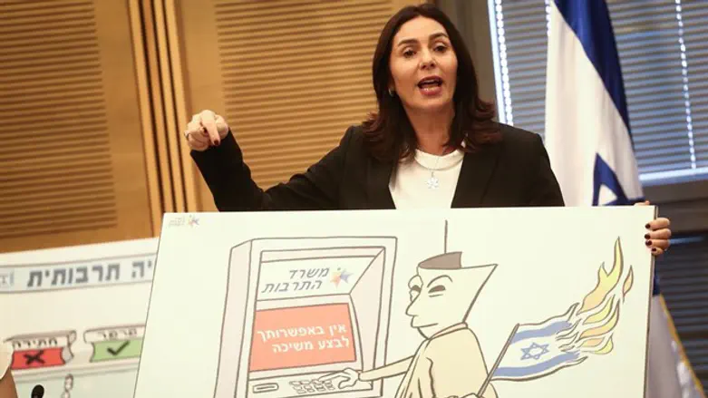 Regev displays political cartoon