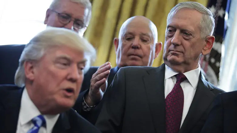 US Defense Secretary James Mattis looks at US President Donald Trump