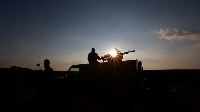 Popular Mobilization Forces (PMF) fighter rides military vehicle