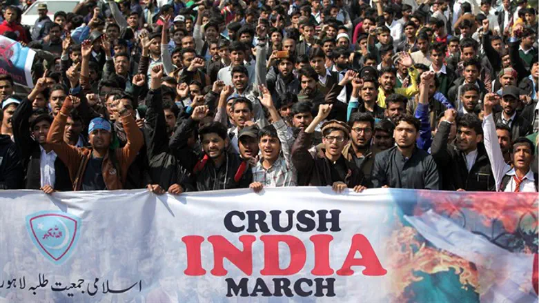 Supporters of Jamiat Talaba Islam celebrate after Pakistan downs Indian planes