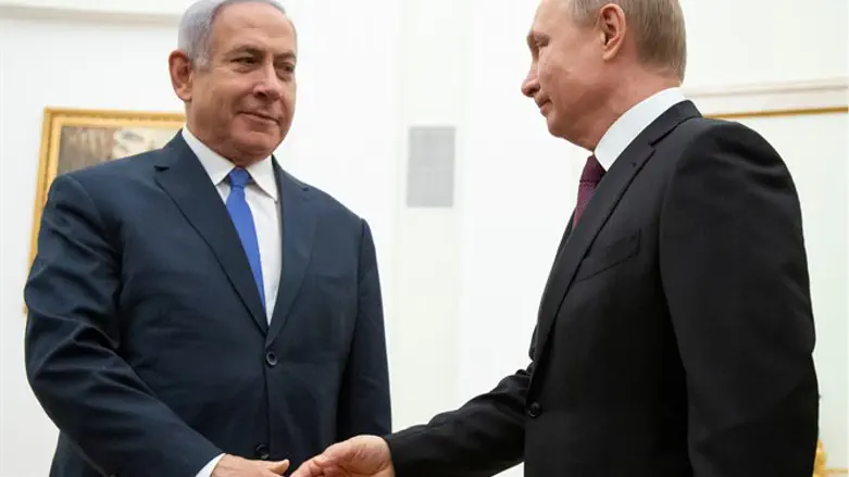 Russian President Vladimir Putin, shakes hands with Israeli Prime Minister Binya