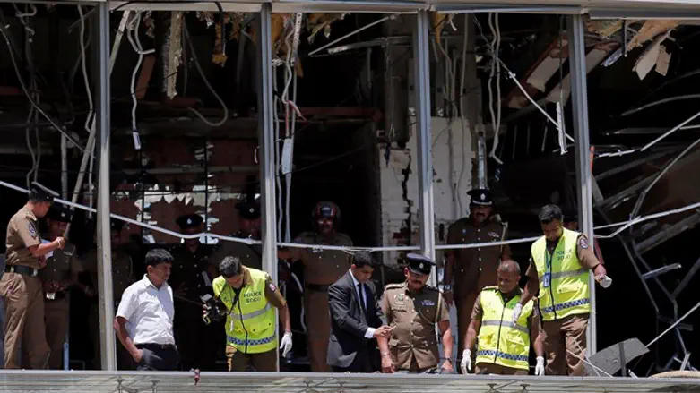Crime scene officials inspect the explosion area at Shangri-La hotel in Colombo