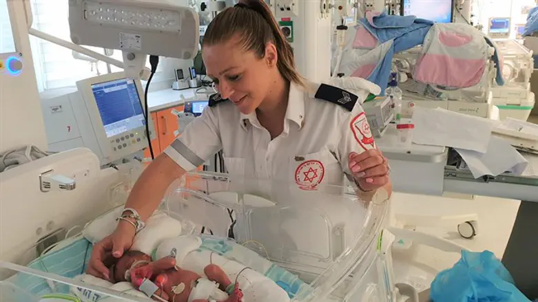 MDA paramedic Lita Branzon visits her preemie son in the NICU