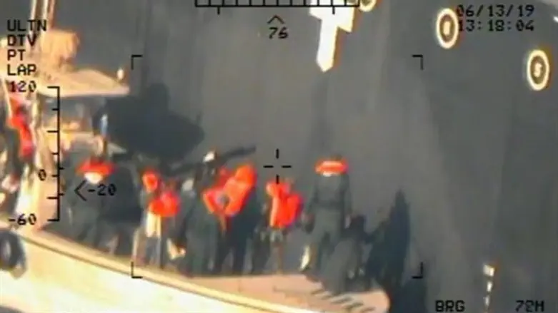 US military image of Iranian personnel removing unexploded mine from vessel