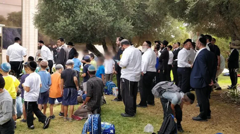 Parents and students pray during demonstration