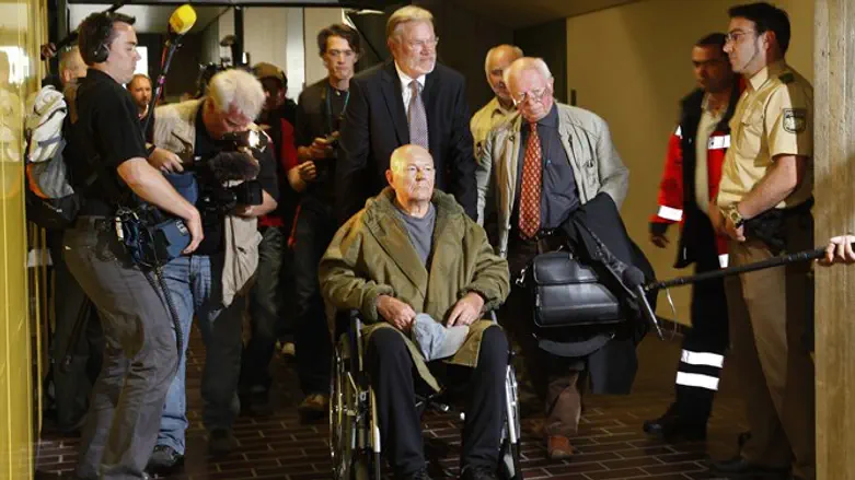 John Demjanjuk leaves a courtroom after his the verdict in Munich