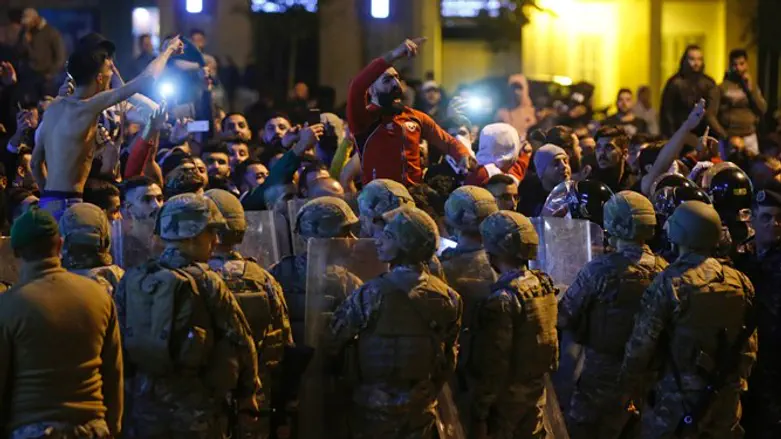 Clashes between anti-government demonstrators and Hezbollah supporters in Beirut