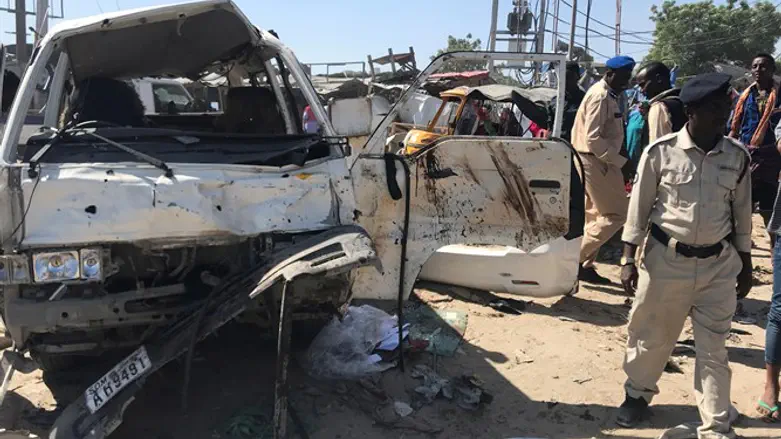Security officers at the scene of a truck bombing near a tax office in Mogadishu, Somalia