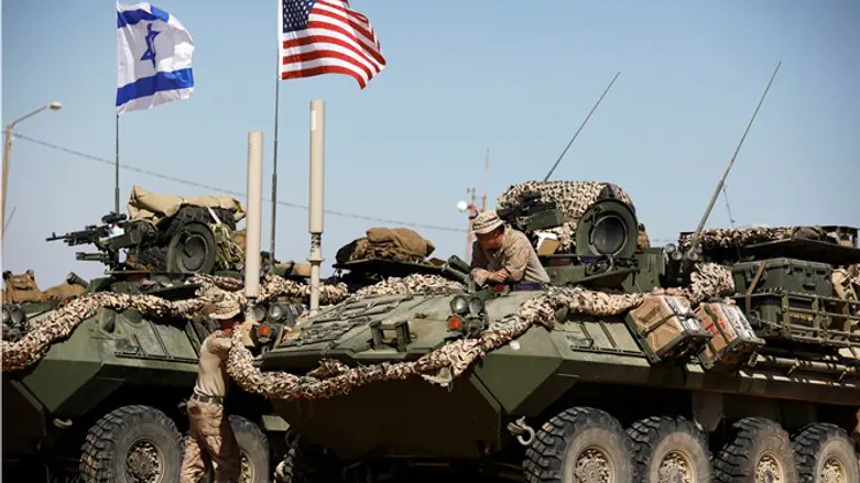U.S. Marine sits on top of an armoured personnel carrier during Juniper Cobra