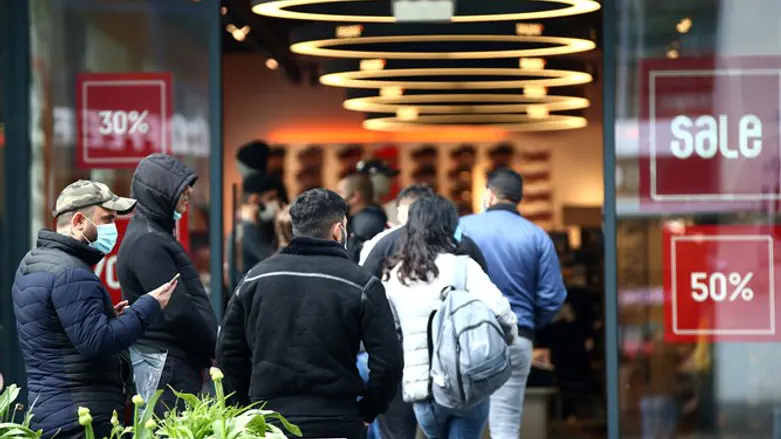 Customers line up outside store after Austrian government loosens lockdown