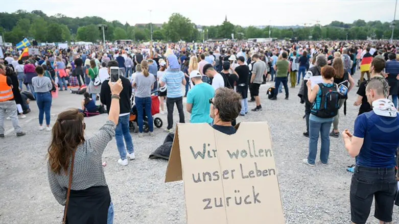 A protester carries a sign with the inscription "We want our life back"