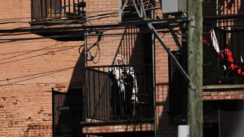 Hasidic man prays on his balcony in Brooklyn, April 25, 2020