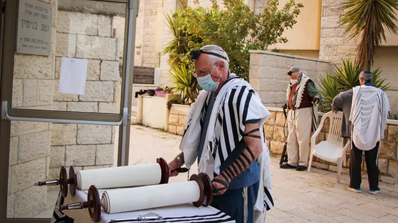 Jews holding prayers outside a synagogue in Efrat