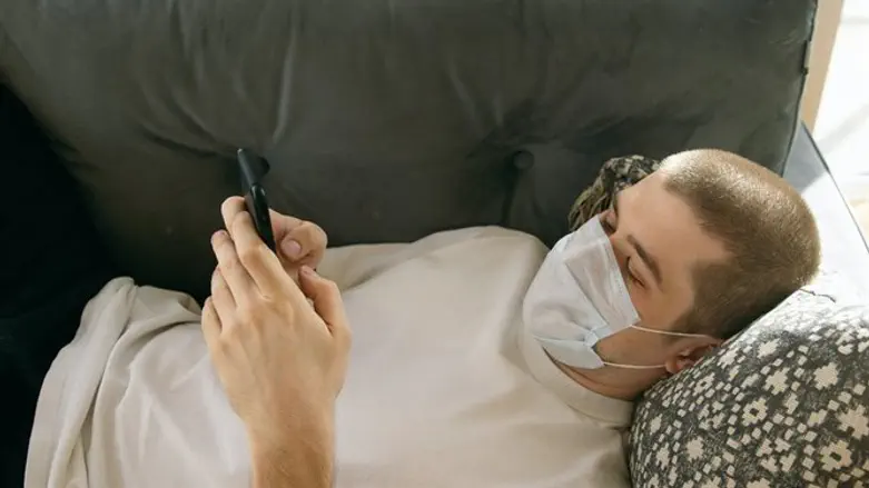 Man with mask on phone