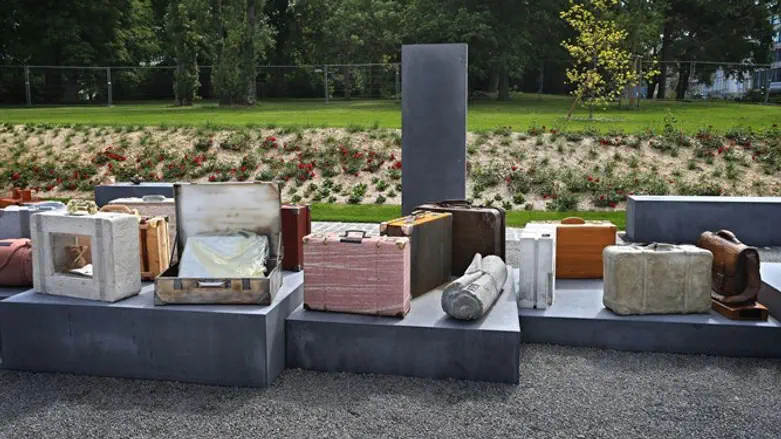 Stylized pieces of luggage stand at a memorial for deported Jews in Wurzburg