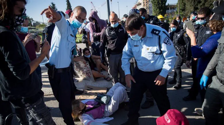 Demonstrators protest outside of the Knesset
