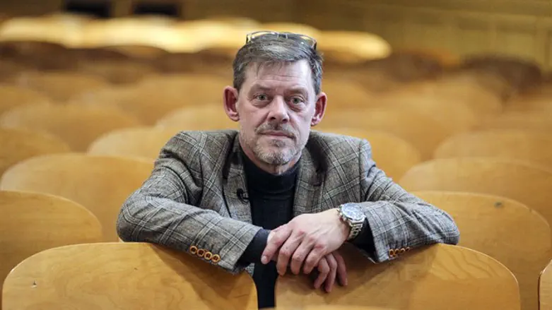 Rainer Hoess poses at a school after speaking to students about his grandfather'