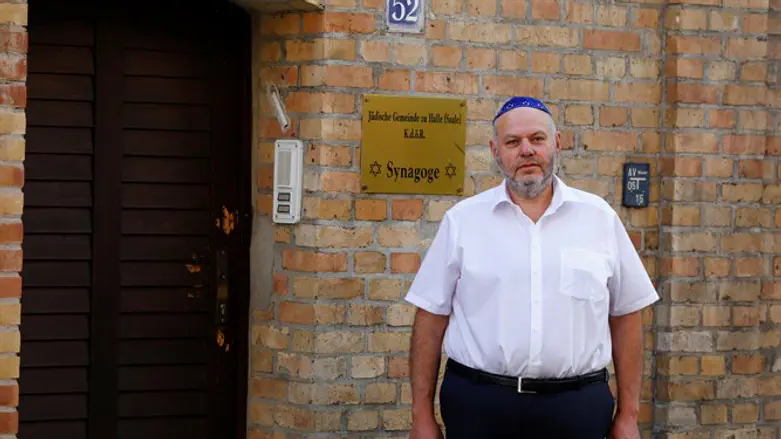 Max Privorozki, head of Halle's Jewish community, stands in front of the synagogue