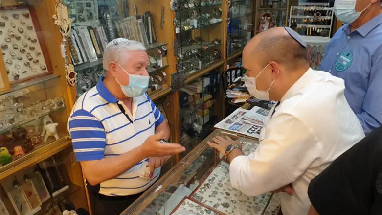 Bennett with business owners in Zion Square